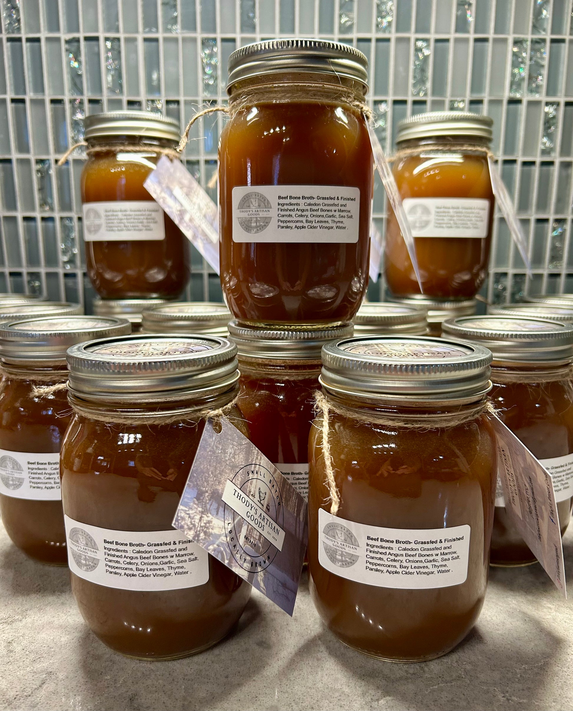 Jars of Grass Fed Beef Bone Broth with labels on the jars