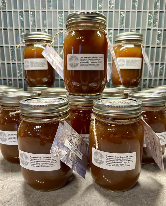 Jars of Grass Fed Beef Bone Broth with labels on the jars